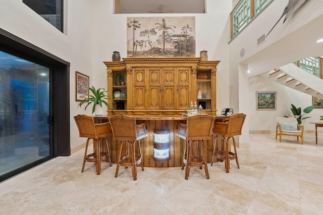 bar with a high ceiling and ceiling fan