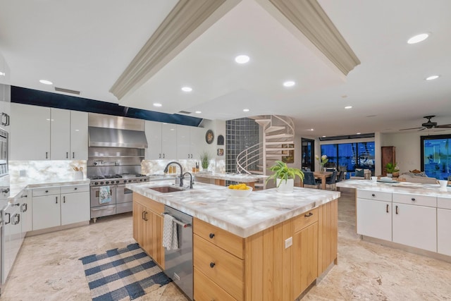 kitchen with white cabinets, a center island with sink, and stainless steel appliances