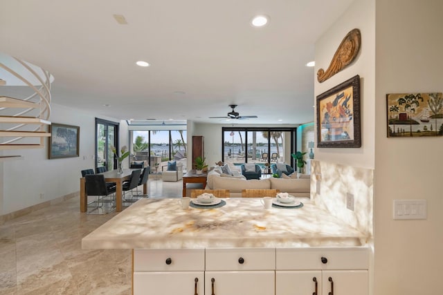 kitchen with white cabinets and ceiling fan