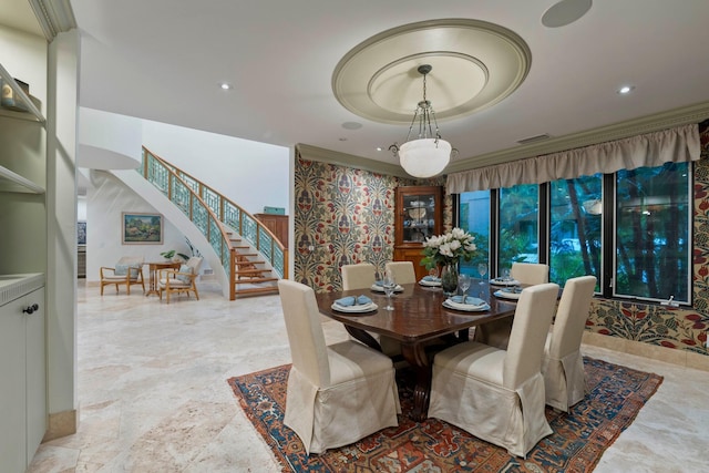 dining area featuring a tray ceiling and crown molding