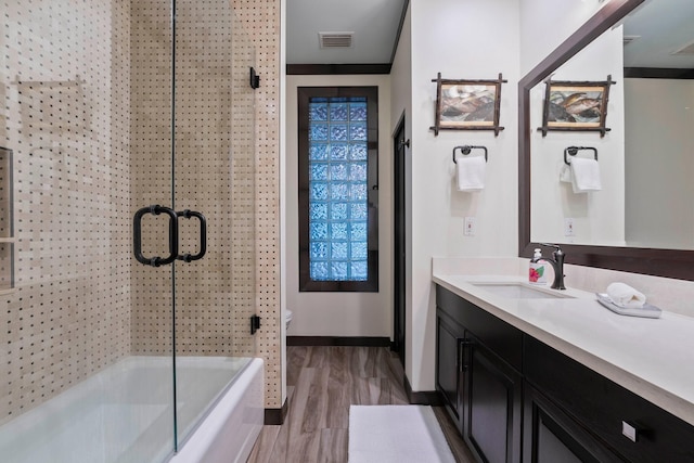 bathroom featuring vanity, hardwood / wood-style flooring, and toilet