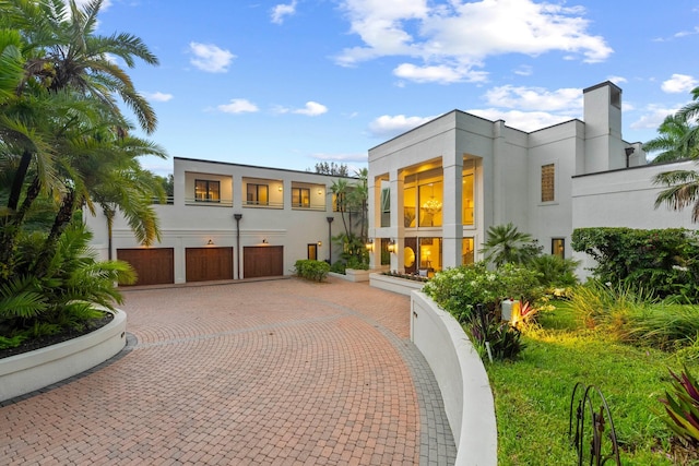 rear view of house featuring a garage