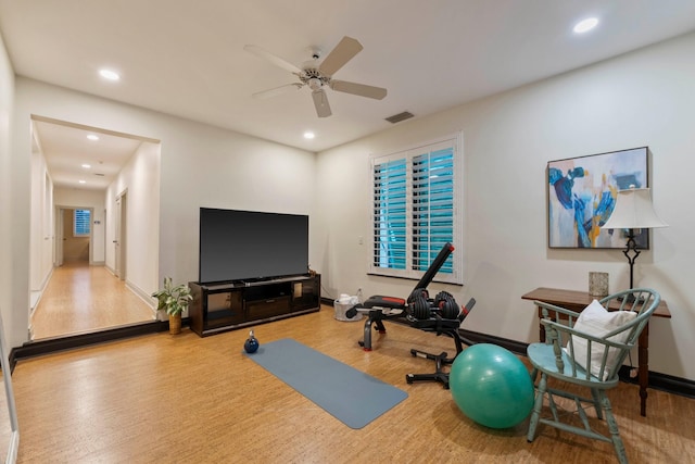 workout room with light hardwood / wood-style flooring and ceiling fan