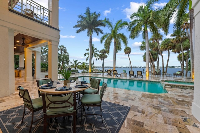 view of pool with a patio area and a water view