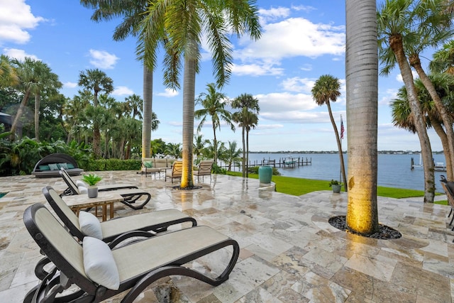 view of patio with outdoor lounge area and a water view