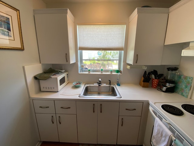 kitchen with white cabinets, exhaust hood, white appliances, and sink