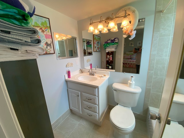 bathroom with tile patterned floors, vanity, and toilet