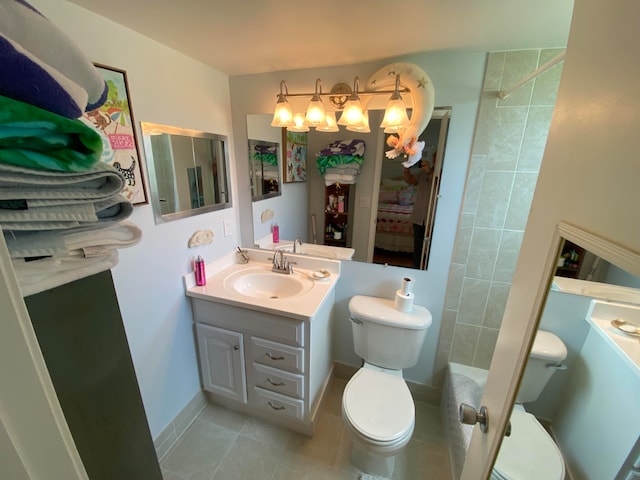 bathroom featuring tile patterned floors, vanity, and toilet