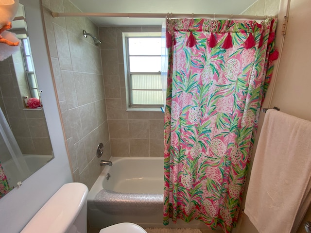 bathroom with toilet and shower / tub combo