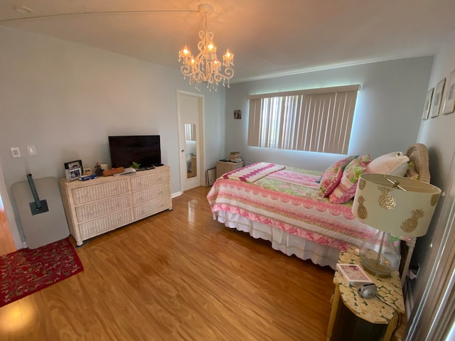 bedroom featuring wood-type flooring and a notable chandelier