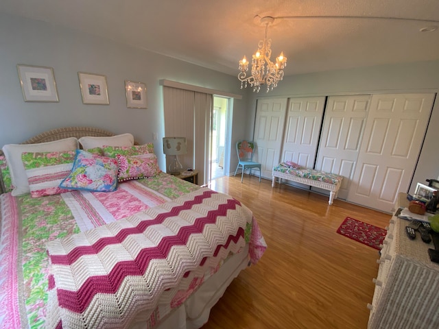 bedroom featuring a closet, hardwood / wood-style floors, and a notable chandelier