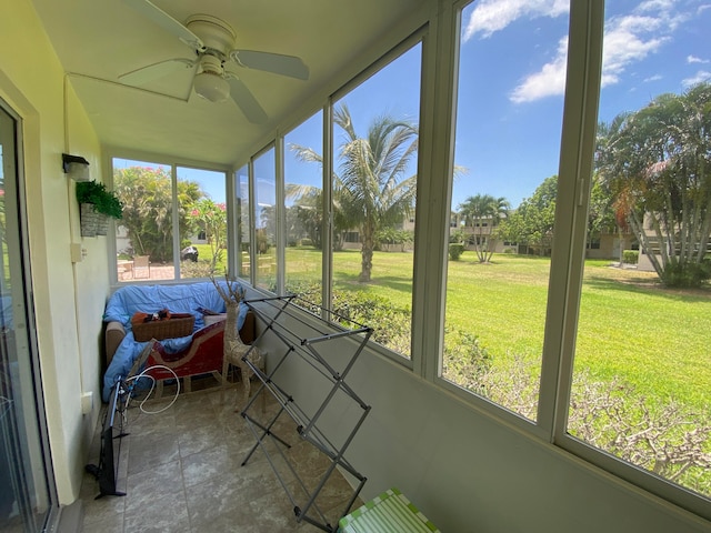 sunroom featuring ceiling fan