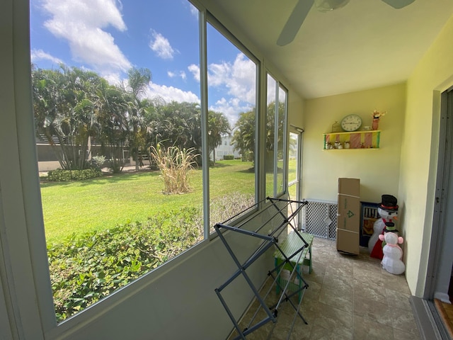 sunroom featuring ceiling fan