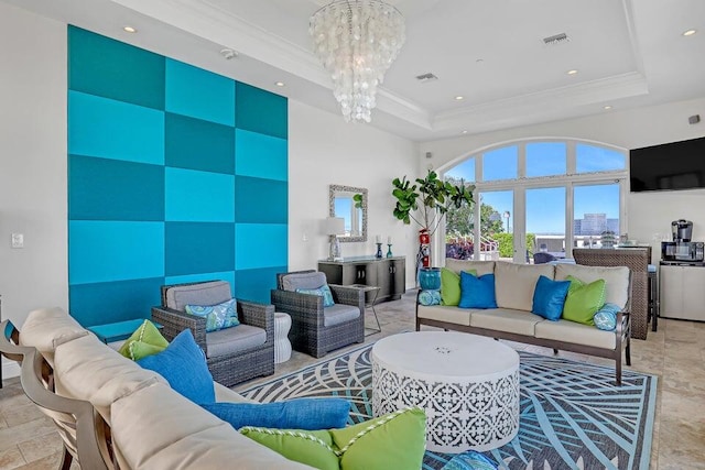 living room with a towering ceiling, tile flooring, a chandelier, and a raised ceiling