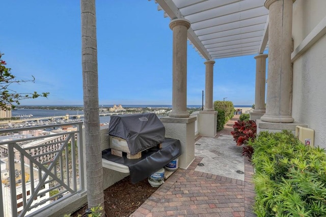 view of patio / terrace featuring a balcony and a water view