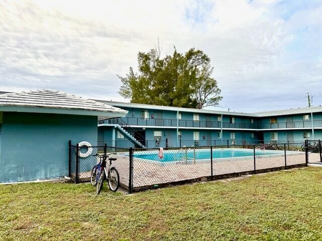 exterior space featuring a community pool and a lawn