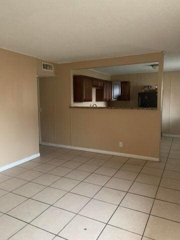 spare room featuring light tile floors