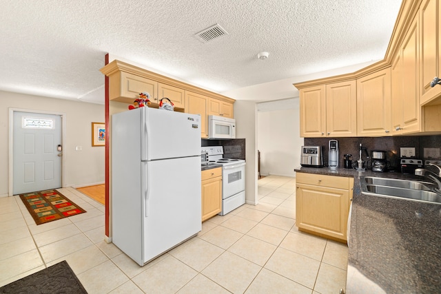 kitchen with white appliances, backsplash, sink, light tile flooring, and light brown cabinets