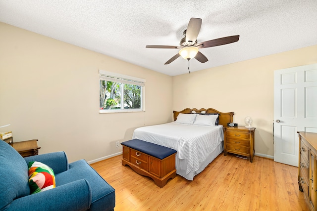 bedroom featuring a textured ceiling, ceiling fan, and light hardwood / wood-style flooring