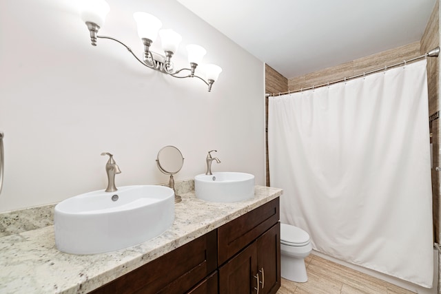 bathroom featuring double sink vanity and toilet