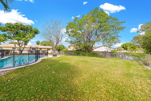 view of yard with a fenced in pool