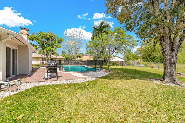 view of yard with a fenced in pool and a patio