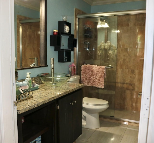 bathroom with vanity, tile patterned flooring, toilet, and a shower with door