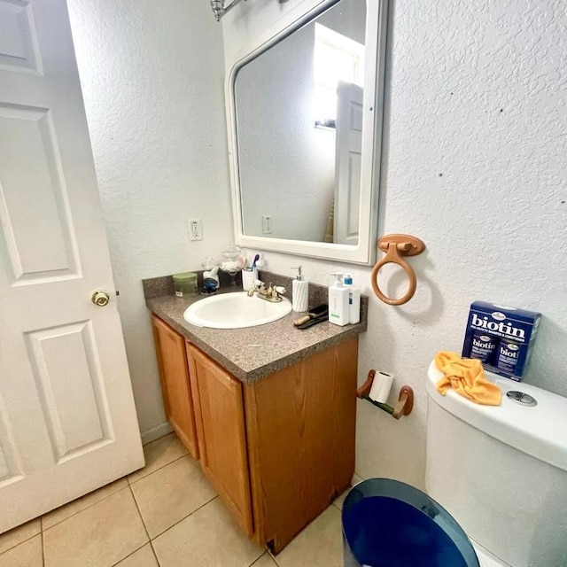 bathroom with vanity, tile patterned flooring, and toilet