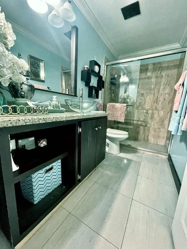 bathroom with vanity, ornamental molding, tile patterned floors, toilet, and a shower with door