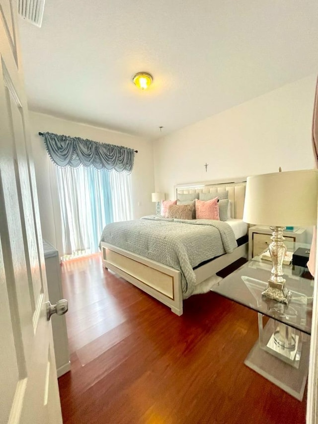 bedroom with dark wood-type flooring