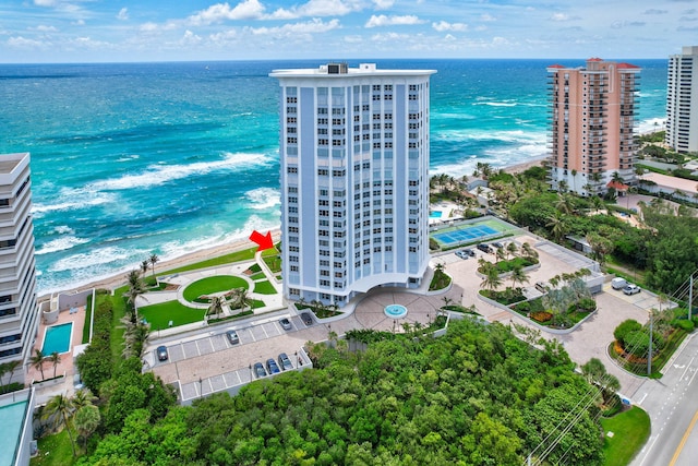 drone / aerial view with a water view and a beach view