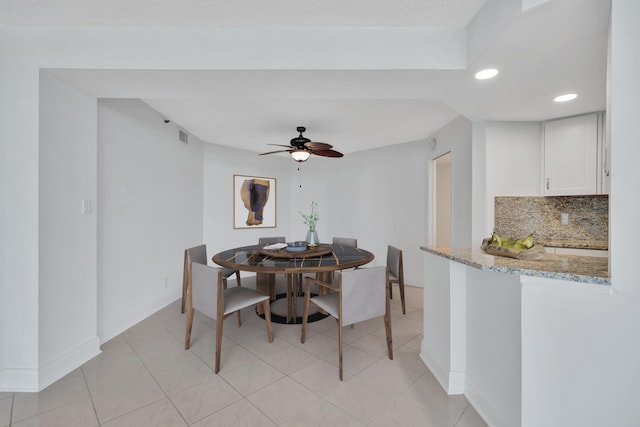 tiled dining space with ceiling fan