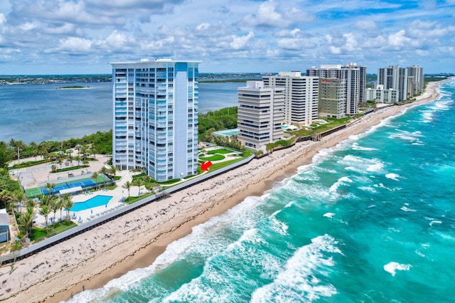 drone / aerial view with a water view and a beach view