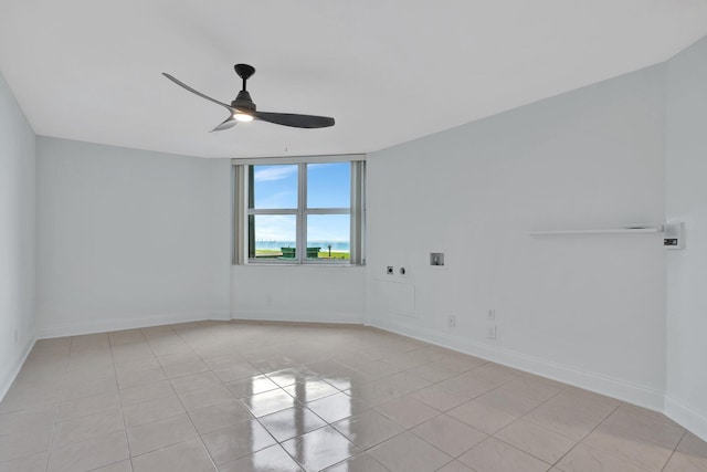 empty room featuring ceiling fan and light tile patterned flooring