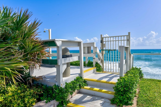 view of community featuring a beach view and a water view