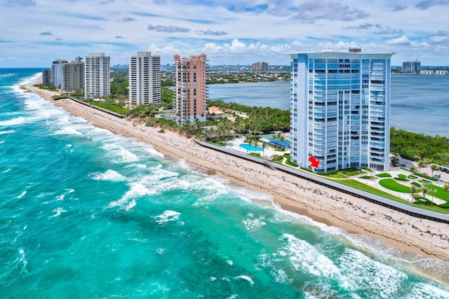 bird's eye view featuring a water view and a beach view