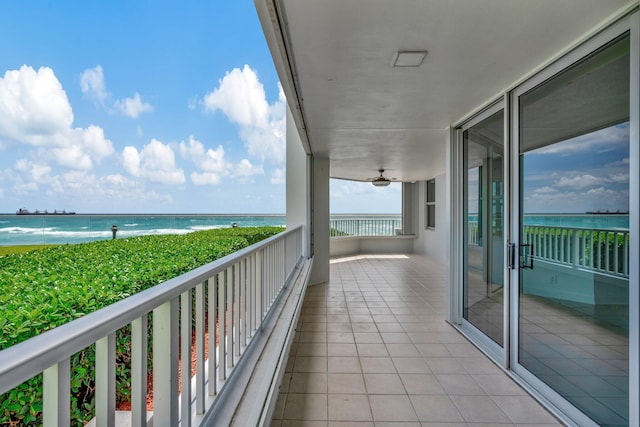 balcony with a water view and ceiling fan