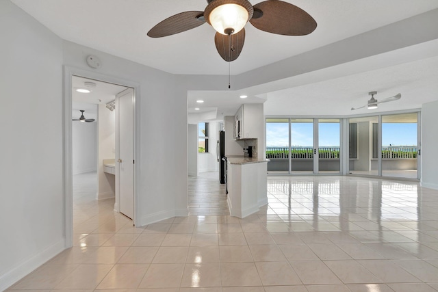 tiled spare room with floor to ceiling windows and plenty of natural light