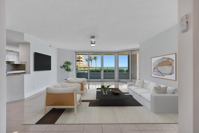 living room with expansive windows and light tile patterned floors