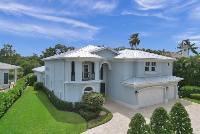 view of front of home featuring a garage and a front lawn