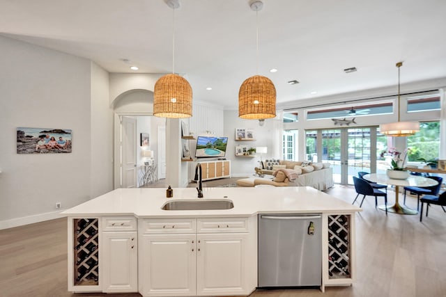 kitchen with pendant lighting, a center island with sink, and sink