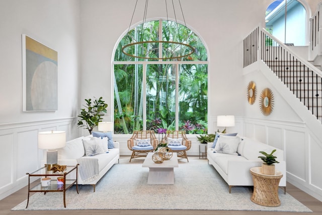 living area featuring a high ceiling and light hardwood / wood-style flooring