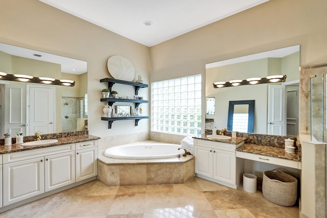 bathroom featuring vanity, plus walk in shower, and tile patterned flooring