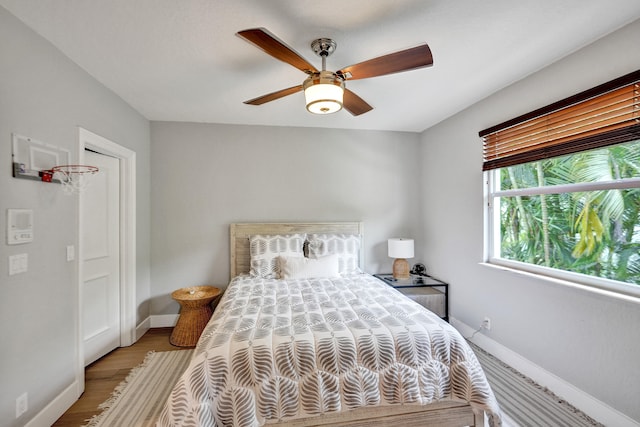 bedroom with hardwood / wood-style flooring and ceiling fan