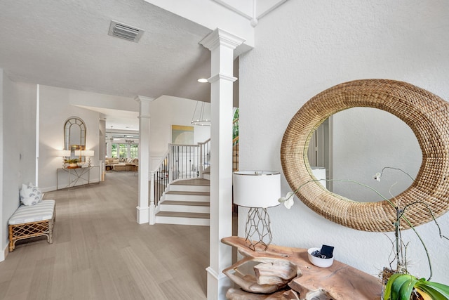 corridor featuring light hardwood / wood-style floors and a textured ceiling