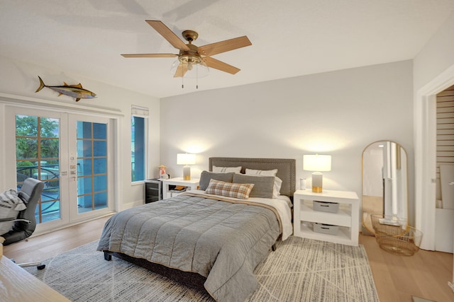 bedroom with ceiling fan, access to exterior, light hardwood / wood-style flooring, and french doors