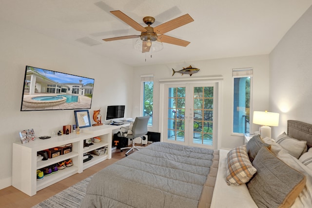 bedroom featuring french doors, hardwood / wood-style flooring, and ceiling fan