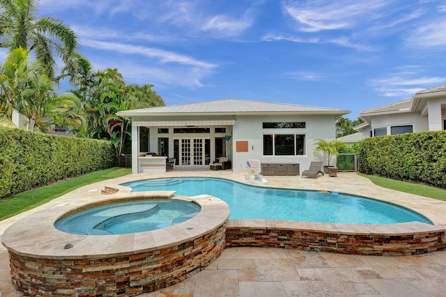 view of swimming pool with french doors, a patio, and an in ground hot tub