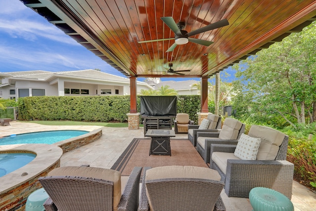 view of patio / terrace featuring an outdoor living space, a swimming pool with hot tub, and ceiling fan