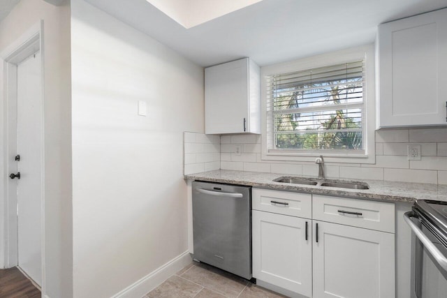 kitchen with white cabinets, backsplash, and stainless steel appliances